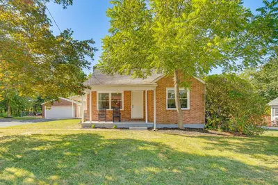 a small brick house with a tree in front of it at York Farmhouse Hideaway Near Lake Redman in York