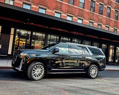 a black car parked in front of a building at New York shuttles in Brooklyn