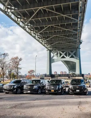 a group of cars parked under a bridge at New York shuttles in Brooklyn