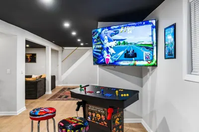 a living room with a flat screen tv on a wall at Pocono Speak Easy Hot Tub Golf Simulator 1920 Bar in East Stroudsburg