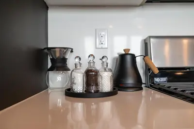 a group of glass bottles sitting on a kitchen counter at Luxe 1br- Free Parking-King Bed in East Orange
