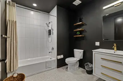 a bathroom with a shower toilet and a sink at Luxe 1br- Free Parking-King Bed in East Orange