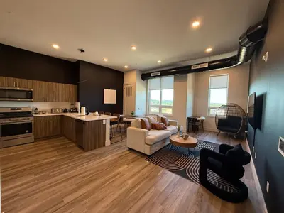 a large living room with a couch and a kitchen at NYC View, Free Parking, 2bath in East Orange