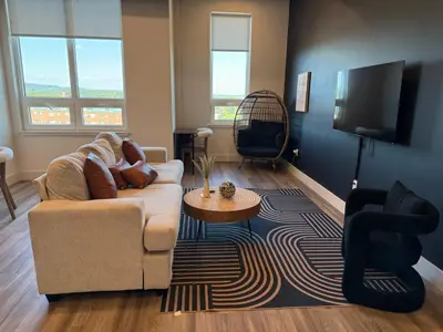 a living room with a couch and a tv at NYC View, Free Parking, 2bath in East Orange