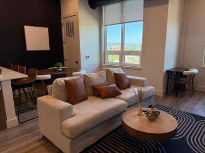 a living room with a couch and a table at NYC View, Free Parking, 2bath in East Orange