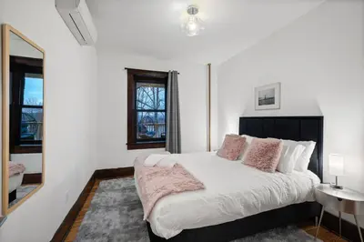 a white bedroom with a large bed with pink pillows at Lakeview-Sleeps 12-King Suites-7BR - Firepit in Monroe