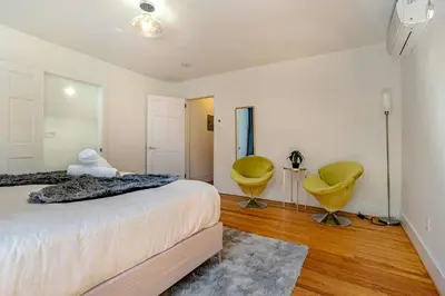 a bedroom with a bed and two yellow chairs at Lakeview-Sleeps 12-King Suites-7BR - Firepit in Monroe