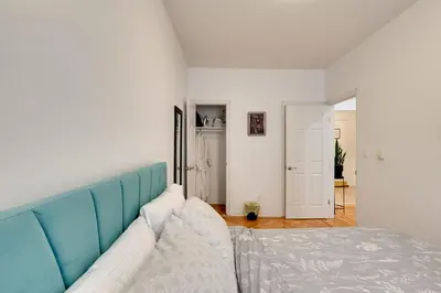 a room with a bed with a blue head board at Cozy Condo Jersey City in Jersey City