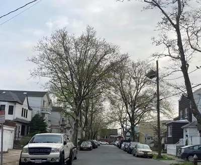 a white truck parked on a street with trees at Cozy Condo Jersey City in Jersey City