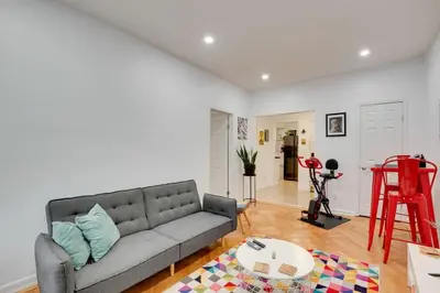 a living room with a couch and a table at Cozy Condo Jersey City in Jersey City