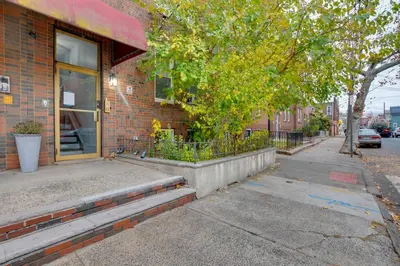 a brick building with a glass door on a street at Cozy Condo Jersey City in Jersey City