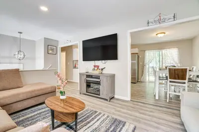 a living room with a couch and a tv at Family Cabin with Hot Tub Game Room Tobyhanna in Tobyhanna