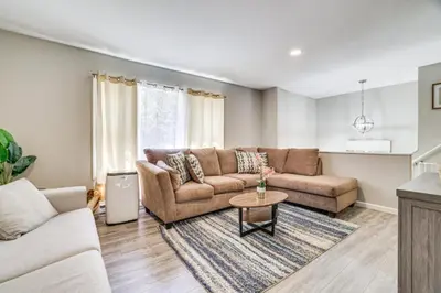a living room with a couch and a table at Family Cabin with Hot Tub Game Room Tobyhanna in Tobyhanna