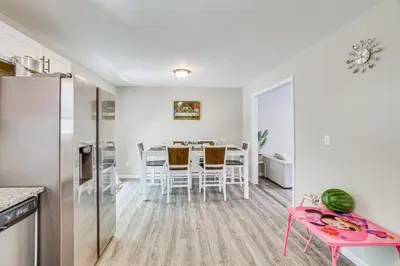 a kitchen and dining room with a table and a refrigerator at Family Cabin with Hot Tub Game Room Tobyhanna in Tobyhanna