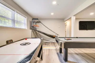 a room with two ping pong tables and a hammock at Family Cabin with Hot Tub Game Room Tobyhanna in Tobyhanna