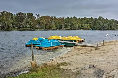 a group of boats parked on the shore of a lake at Family Cabin with Hot Tub Game Room Tobyhanna in Tobyhanna