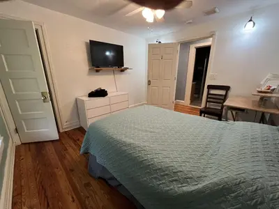 a bedroom with a bed and a flat screen tv at Relaxing, Spacious Private Room near Binghamton in Johnson City