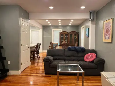a living room with a couch and a table at Relaxing, Spacious Private Room near Binghamton in Johnson City