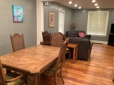 a living room with a table and a couch at Relaxing, Spacious Private Room near Binghamton in Johnson City