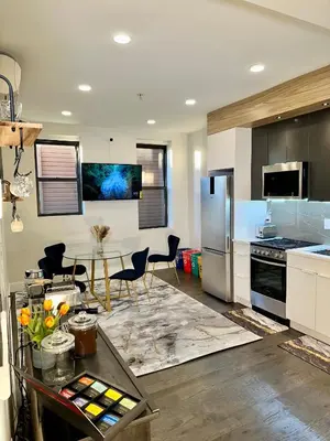 a kitchen with a table and chairs in a kitchen at BP STAYS - Hotel-Style, No Host, Professionally Managed ID286 in Jersey City