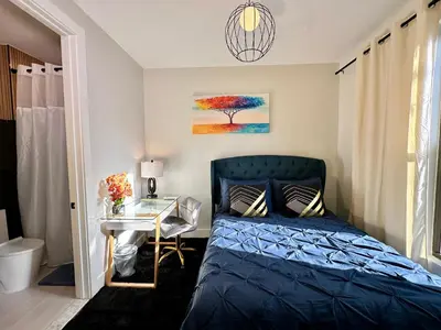 a bedroom with a blue bed and a desk at BP STAYS - Hotel-Style, No Host, Professionally Managed ID286 in Jersey City