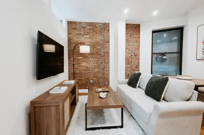 a living room with a couch and a table at Spacious 3BR Upper West Side Apt - Steps from Central Park in New York