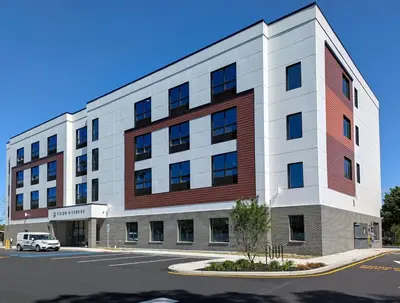 a largeartment building with a car parked in front of it at 401 Modern Brand New Studio Apartment in Old Bridge