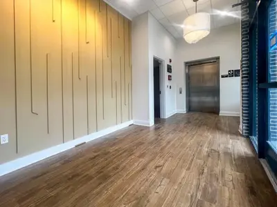 an empty room with wood floors and a hallway at 416 Modern Brand New Studio Apartment in Old Bridge