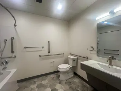 a bathroom with a toilet and a sink and a mirror at 413 Modern Brand New Studio Apartment in Old Bridge