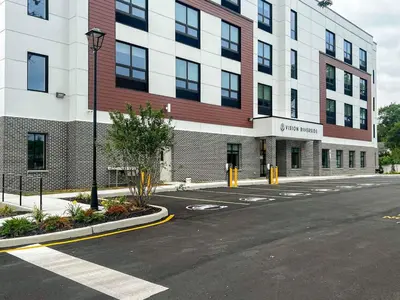 an empty street in front of a large building at 413 Modern Brand New Studio Apartment in Old Bridge