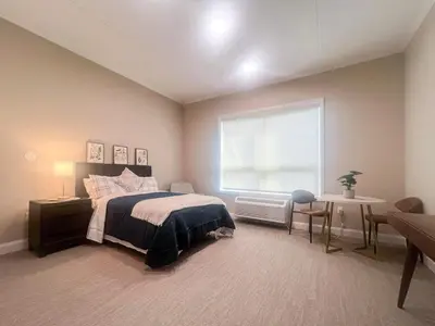 a bedroom with a bed and a large window at 411 Modern Brand New Studio Apartment in Old Bridge