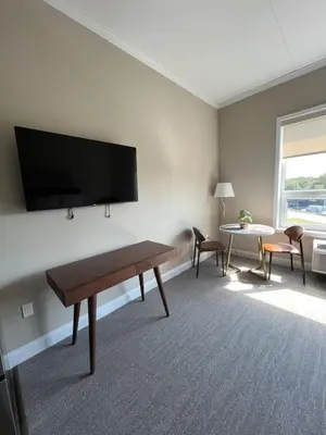 a living room with a flat screen tv on a wall at 410 Modern Brand New Studio Apartment in Old Bridge
