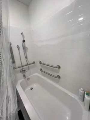 a white bathroom with a bath tub in a room at 410 Modern Brand New Studio Apartment in Old Bridge