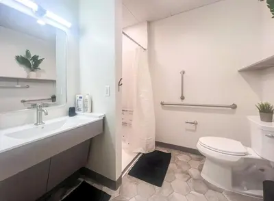 a white bathroom with a toilet and a sink at 409 Modern Brand New Studio Apartment in Old Bridge