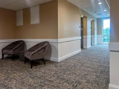 a waiting room in a hospital with two chairs at 408 Modern Brand New Studio Apartment in Old Bridge