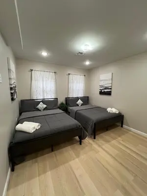 a room with two beds in a room at Modern 2BR and Office Near NYC With Parking - Sleeps 6 in Jersey City