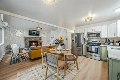 a kitchen and living room with a table and chairs at Pocono Lake Getaway Sauna Hot Tub Playground in Wagners Forest Park