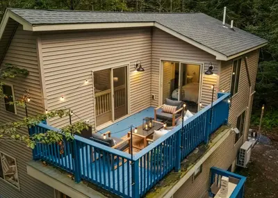 a screened in porch with a blue deck at Pocono Lake Getaway Sauna Hot Tub Playground in Wagners Forest Park