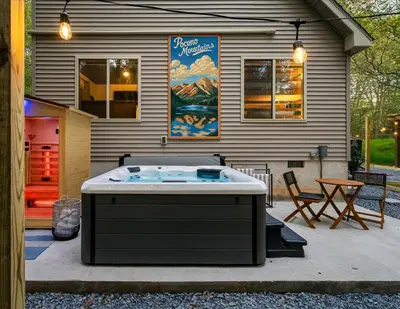 a hot tub sitting outside of a house at Pocono Lake Getaway Sauna Hot Tub Playground in Wagners Forest Park