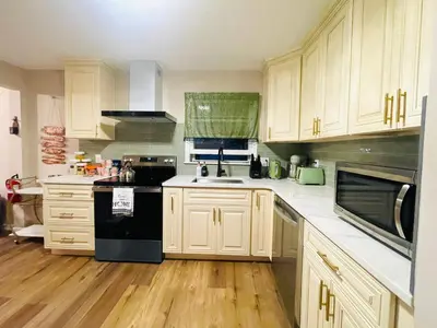 a kitchen with white cabinets and black appliances at Private Estate, Walk to Princeton Downtown, 3-Bedrooms 2-Bath with Free Parking in Princeton
