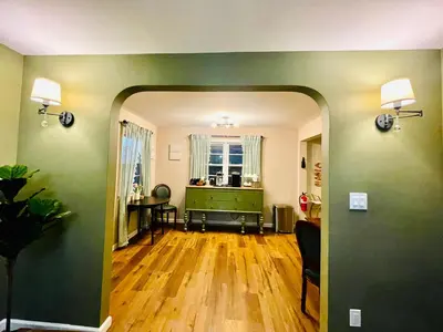 a living room with green walls and a wooden floor at Private Estate, Walk to Princeton Downtown, 3-Bedrooms 2-Bath with Free Parking in Princeton