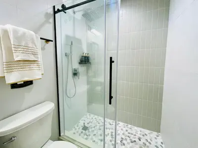 a bathroom with a glass shower with a toilet at Private Estate, Walk to Princeton Downtown, 3-Bedrooms 2-Bath with Free Parking in Princeton