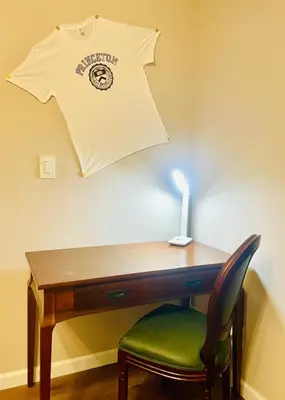 a desk with a chair and a shirt hanging on a wall at Private Estate, Walk to Princeton Downtown, 3-Bedrooms 2-Bath with Free Parking in Princeton