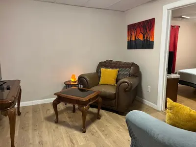 a living room with a couch and a table at Comfy PR near UHS Wilson and BU in Johnson City