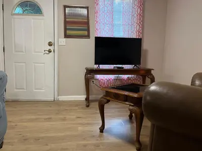 a living room with a desk with a computer on it at Comfy PR near UHS Wilson and BU in Johnson City