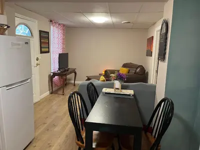 a living room with a table and a couch at Comfy PR near UHS Wilson and BU in Johnson City