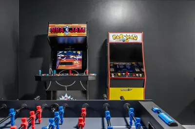 two arcade games and toy figures in a room at Best Deal in the Poconos! in Tobyhanna
