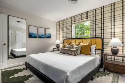 a bedroom with a large bed and a mirror at Best Deal in the Poconos! in Tobyhanna