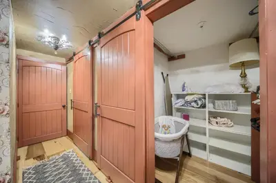 a walk in closet with red doors and a rug at Willow Brook Getaway Hot Tub, Deck in Mifflinburg in Mifflinburg