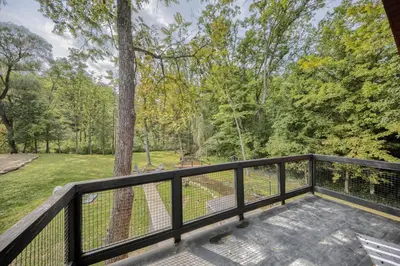a balcony with a view of a park at Willow Brook Getaway Hot Tub, Deck in Mifflinburg in Mifflinburg